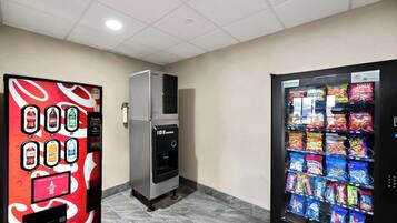 A vending machine area with a beverage dispenser, a water cooler, and a snack vending machine.