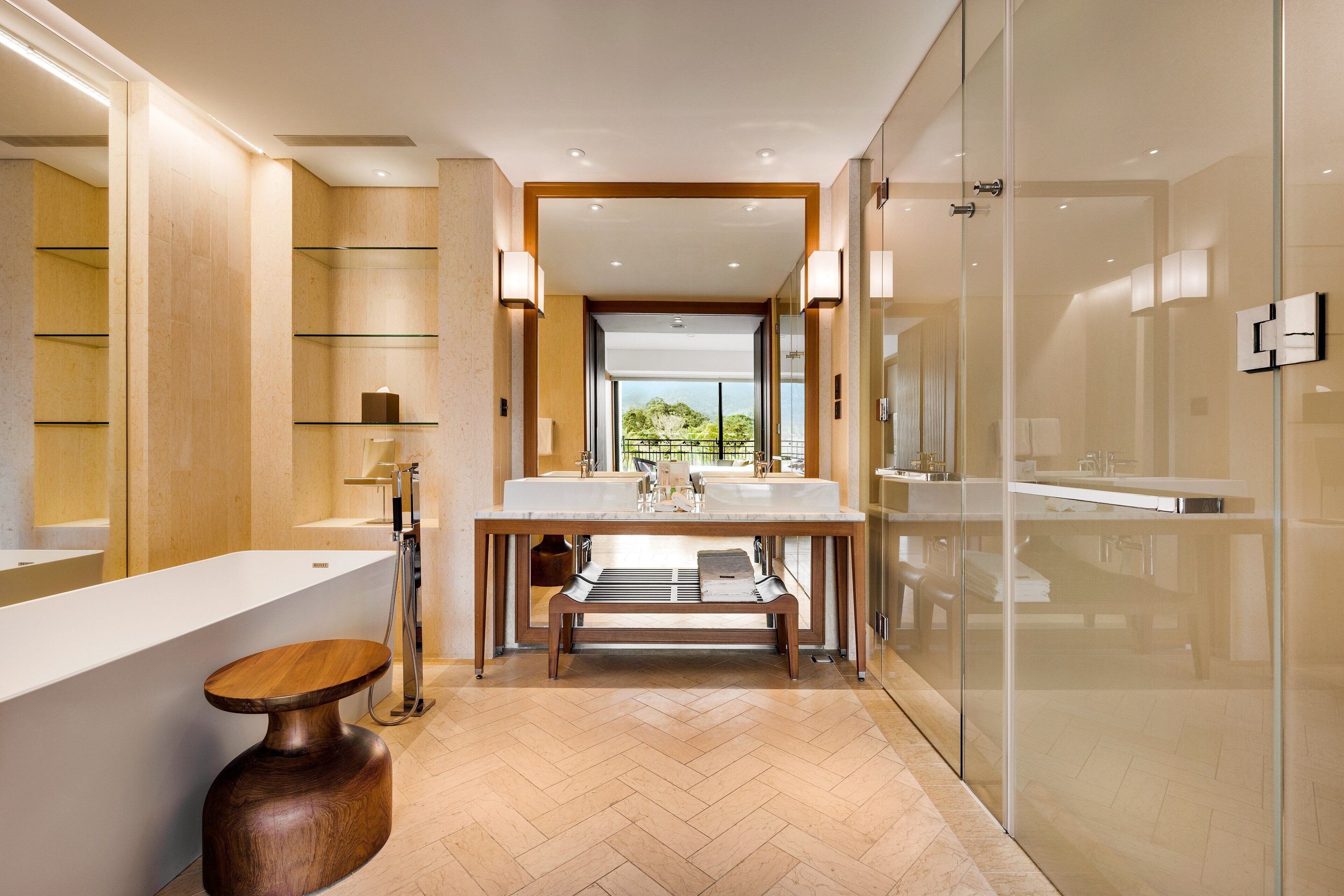 A modern bathroom with a large mirror, a wooden vanity, and a glass shower enclosure.