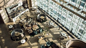 A spacious atrium with multiple seating areas, a bar, and large windows offering views of the city. - Shenzhen Marriott Hotel Nanshan (Shenzhen)