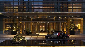 A modern hotel entrance with a glass facade, a reflective pool, and potted plants. - Shenzhen Marriott Hotel Nanshan (Shenzhen)