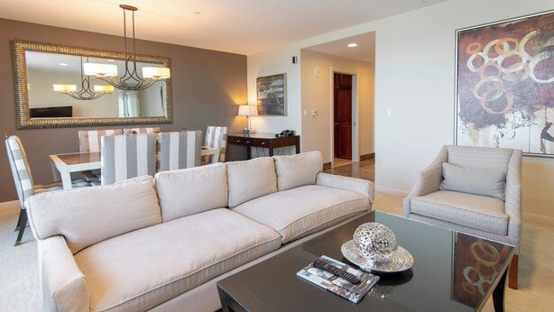 A modern living room with a sofa, armchair, and coffee table. - Broadway Plaza, Trademark Collection by Wyndham (Rochester)
