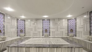 A conference room with a marble table and chairs, patterned walls, and recessed lighting. - Hilton Garden Inn Ankara Gimat (Ankara)