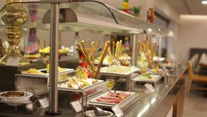 A buffet with various food items and a glass display case. - Hilton Garden Inn Ankara Gimat (Ankara)