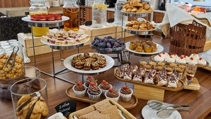 A buffet with various desserts and beverages.