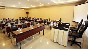 A conference room with multiple tables, chairs, and a projection screen. - Nite & Day Surabaya - Gunungsari (Surabaya)