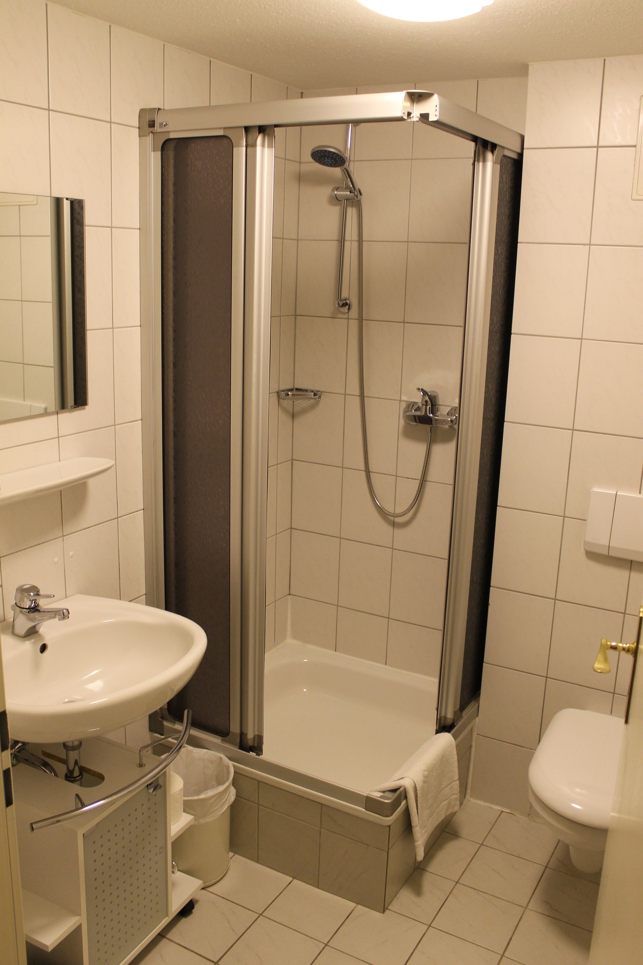 shower, hair dryer, slippers, towels