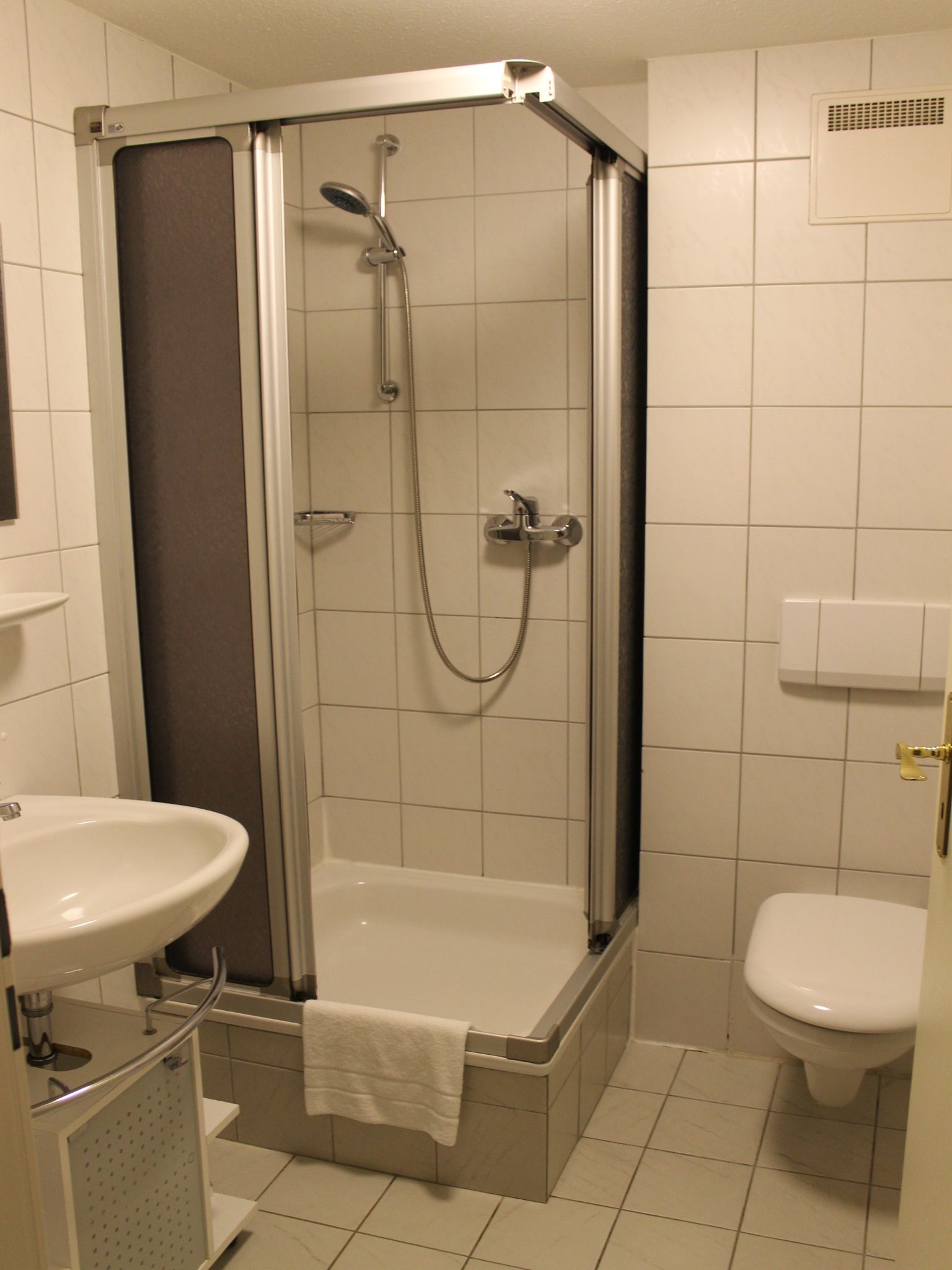 shower, hair dryer, slippers, towels