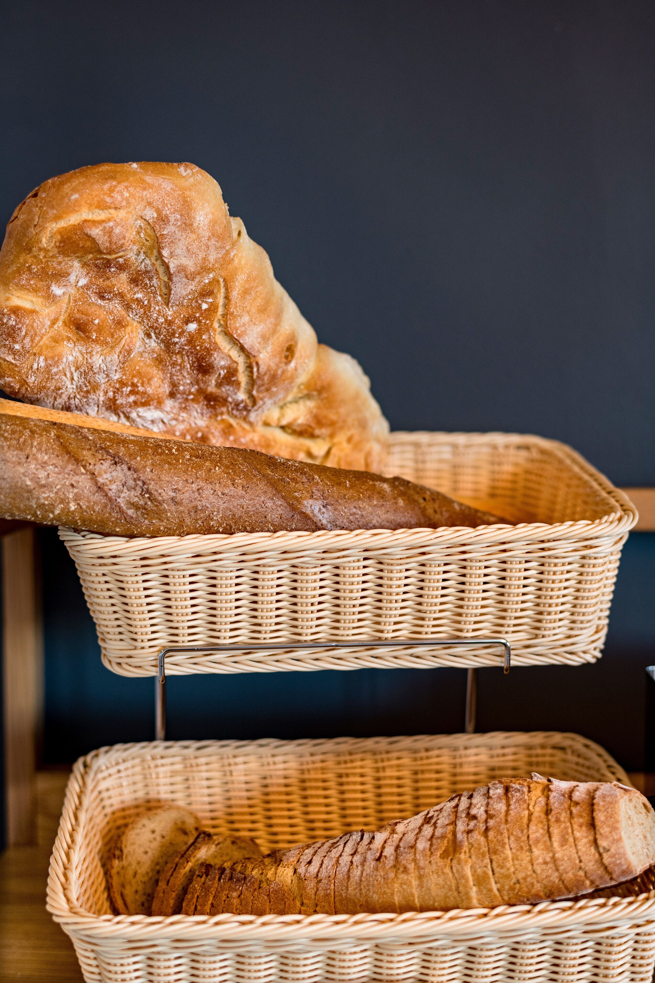 Two wicker baskets containing baguettes.