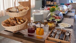 A buffet table with various food items and utensils. - Sea Side Apartments (Chania)