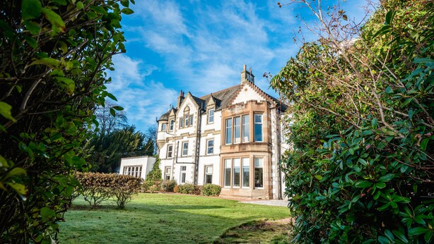 A large, historic building with multiple windows and a well-maintained lawn. - The Park Hotel Peebles (Peebles)