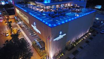 A hotel with a rooftop pool area, a sign for 'InterContinental', and a parking lot.