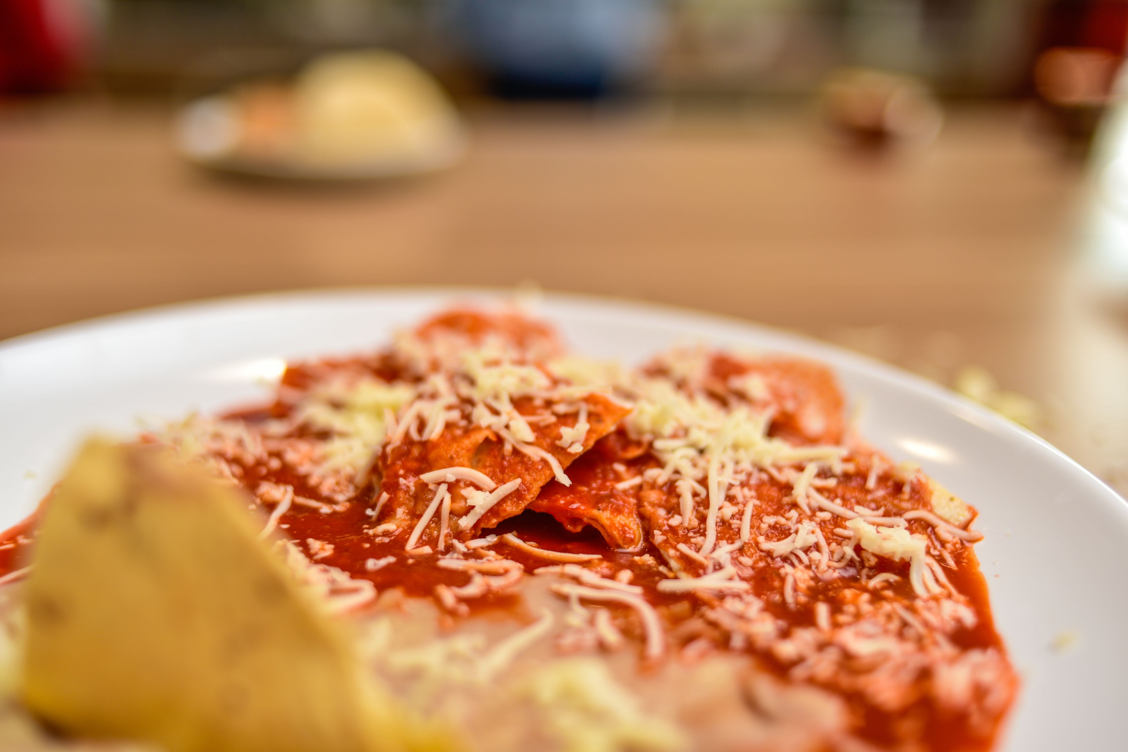 A plate of pasta with tomato sauce and cheese.