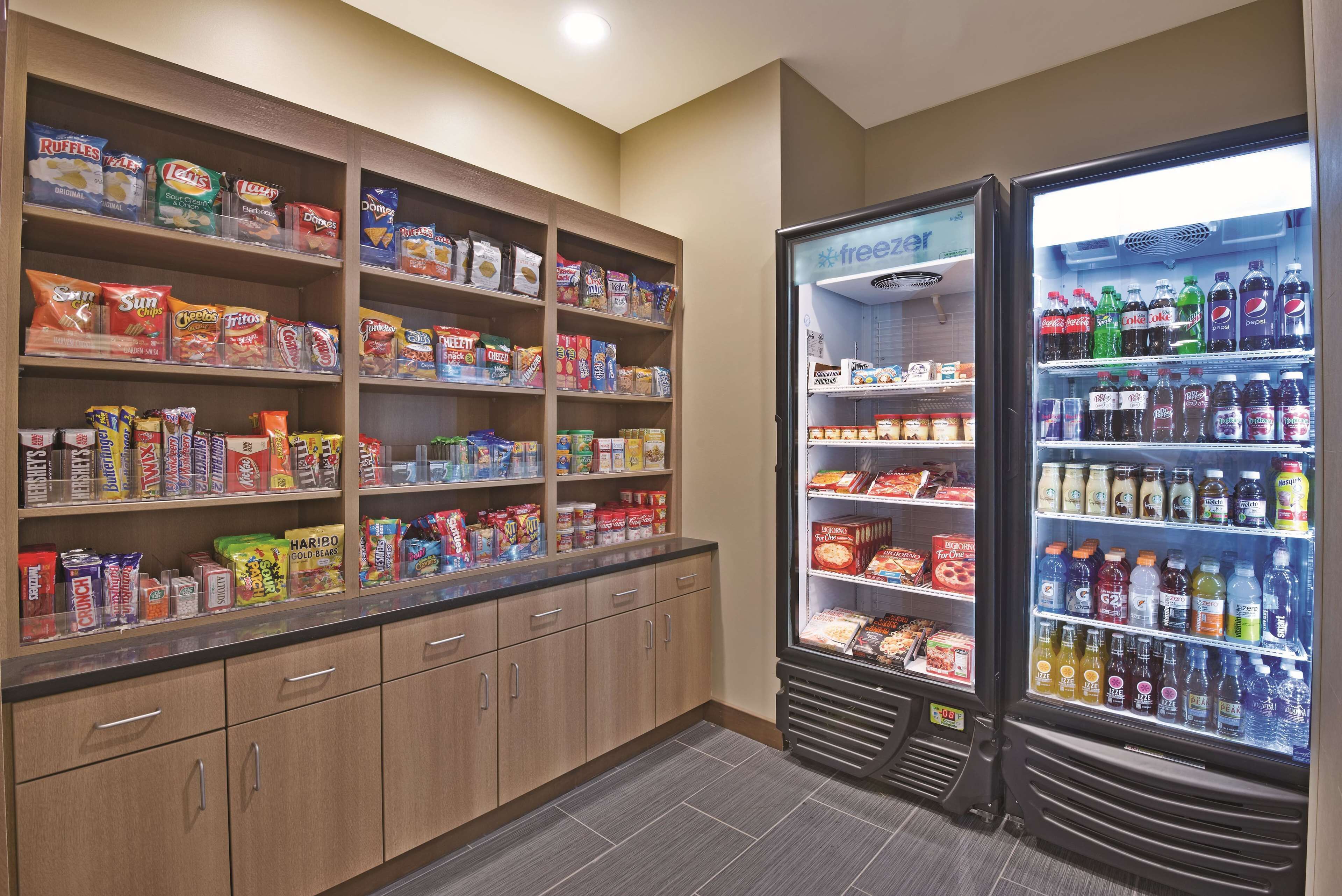 A snack and beverage vending area with various snacks and drinks.