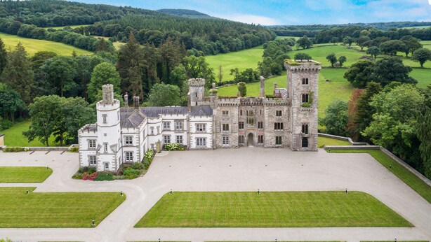 A large, historic castle with multiple towers and a spacious courtyard.