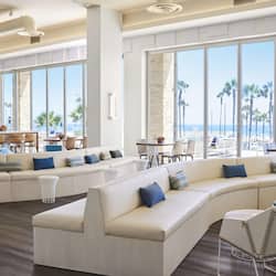 Relax in our spacious lobby with a comfortable sofa, dining area, and stunning ocean views.