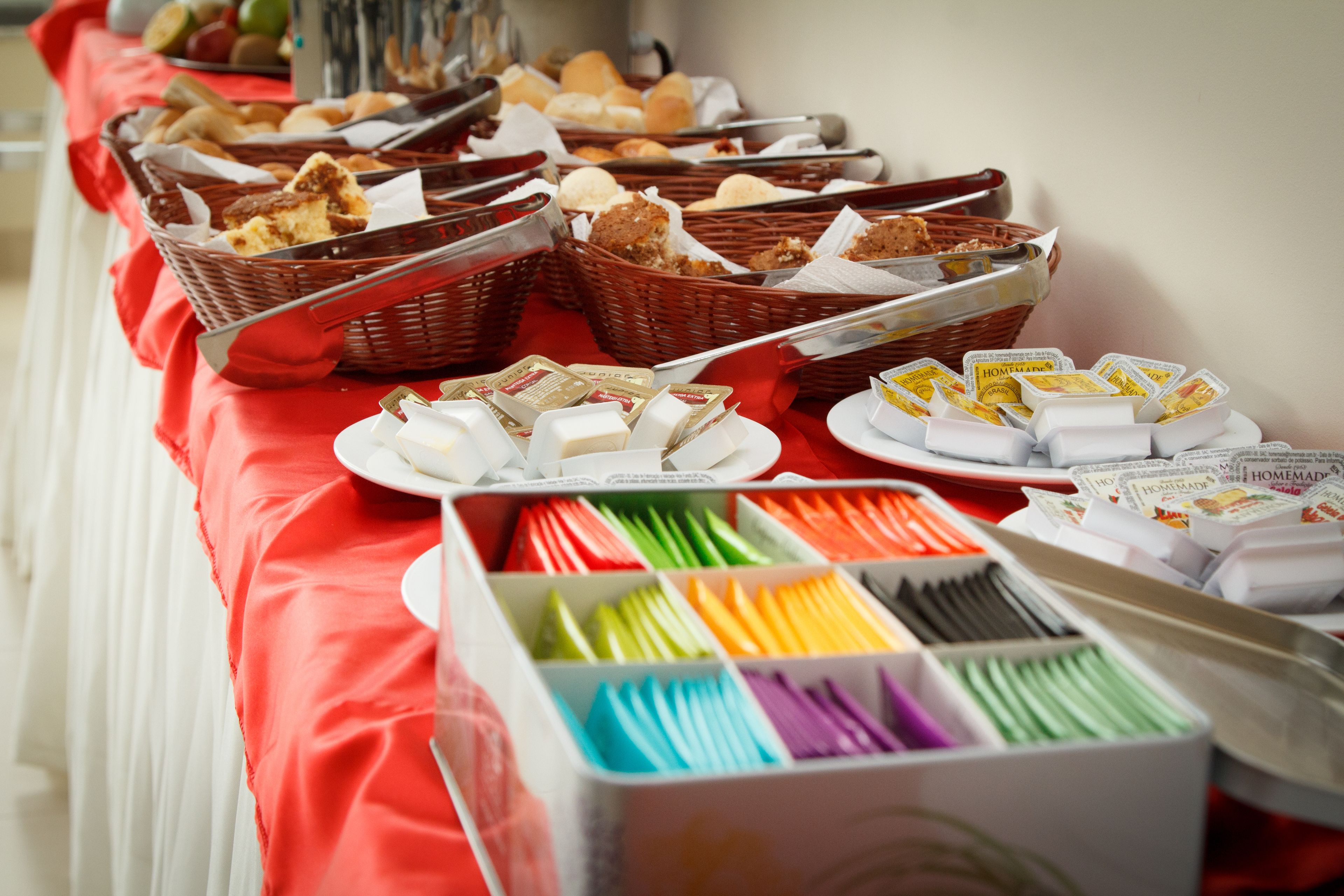 A buffet table with various food items and condiments.