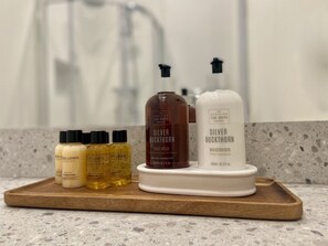 A tray with various personal care products on a countertop. - Antler Guest House (Edinburgh)