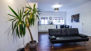 Signature Apartment, 1 Bedroom | Living room | 32-inch flat-screen TV with digital channels, TV, tablet