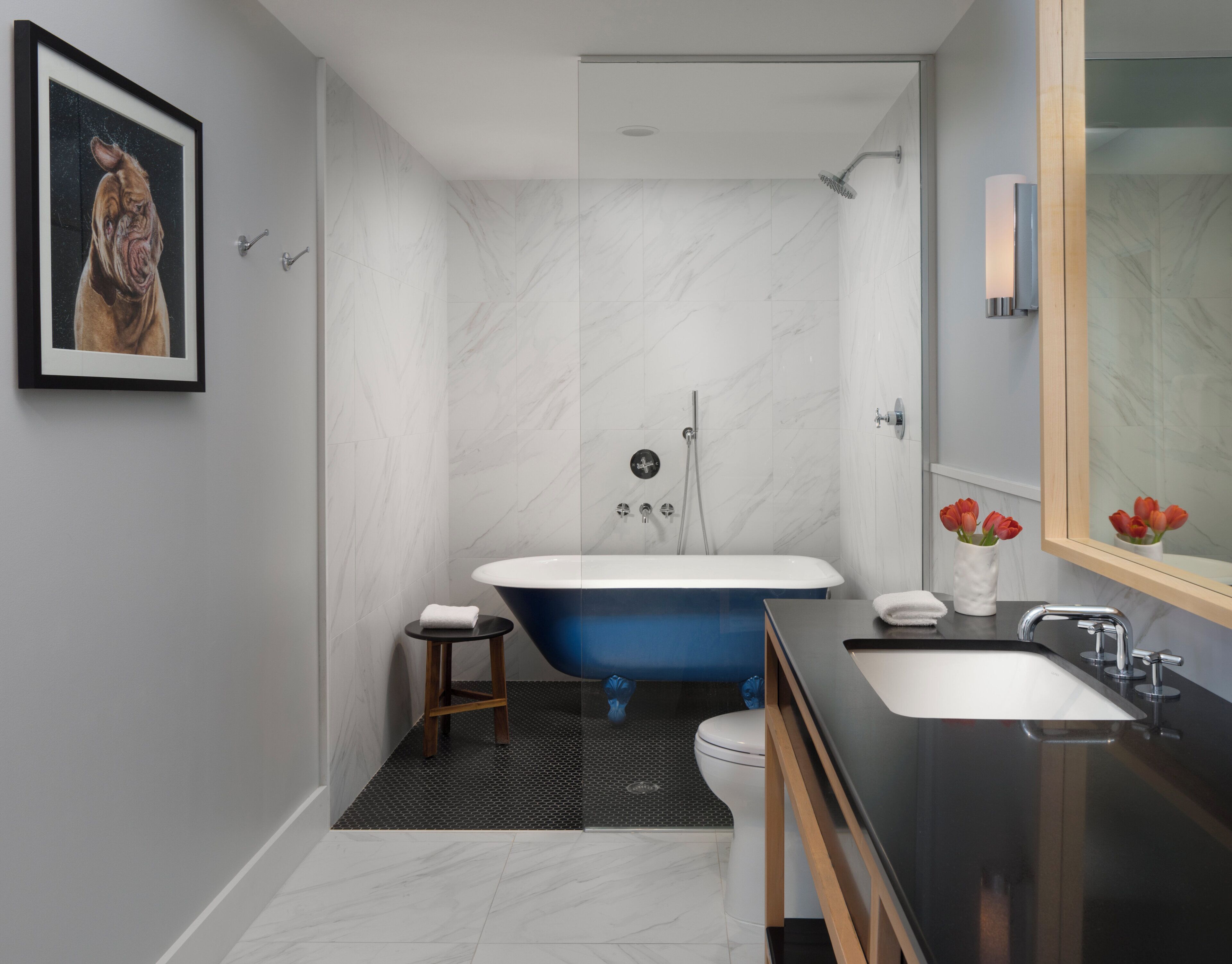 A modern bathroom with a bathtub, shower, toilet, and sink.