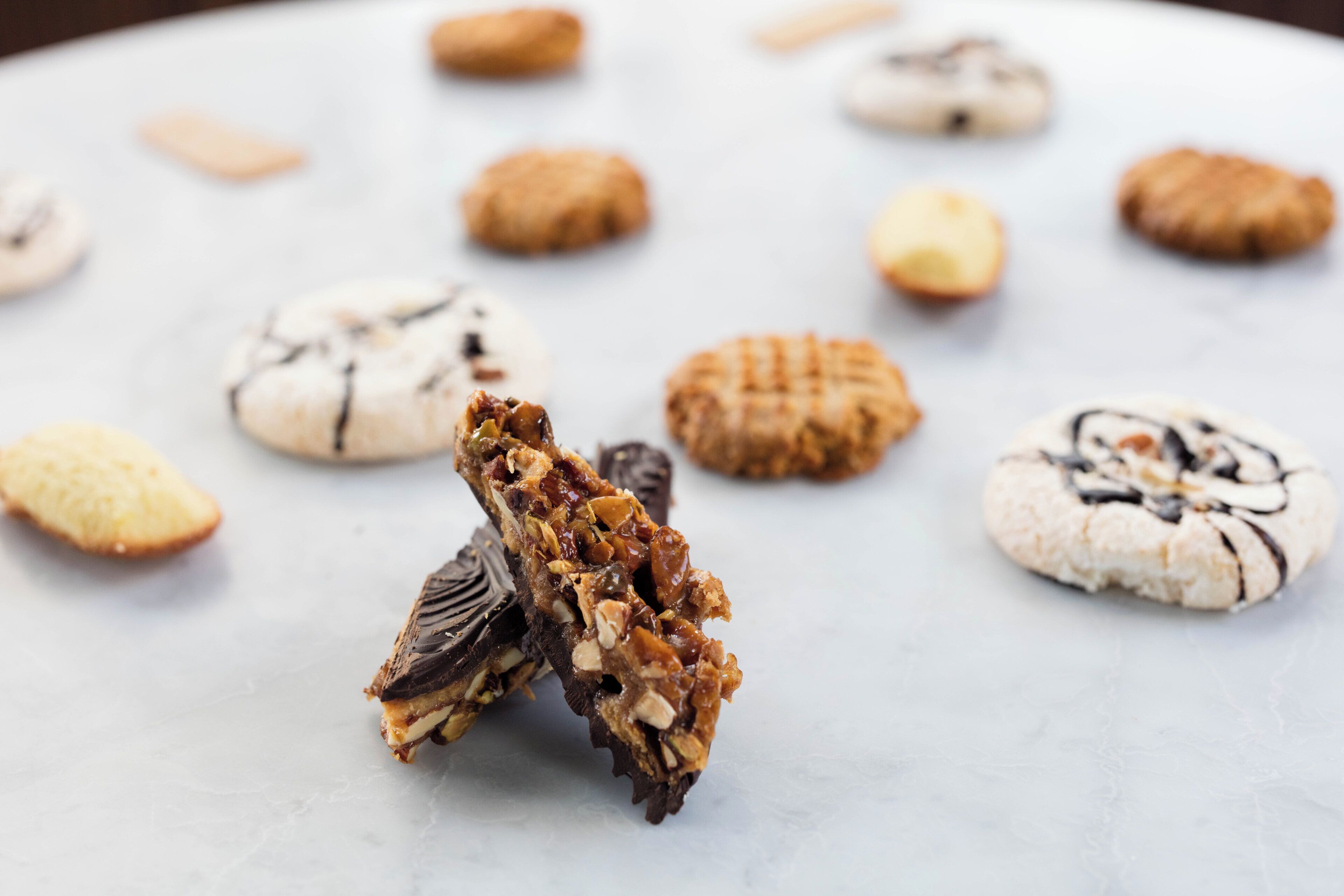 A variety of cookies on a white plate.