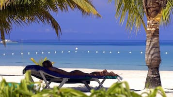 On the beach, sun-loungers, beach towels