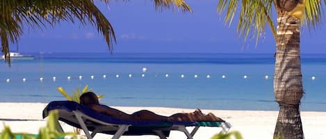 On the beach, sun-loungers, beach towels