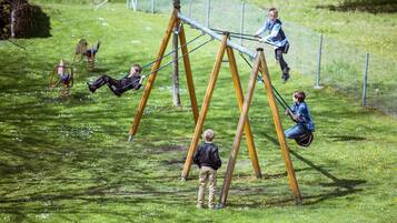 A playground with swings and a climbing structure.