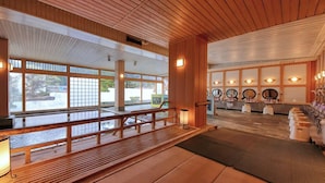 A traditional Japanese onsen with wooden interiors, a reception area, and a view of the outside. - Kinugawa Park Hotels (Nikko)