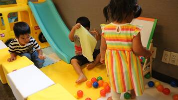 Children can play and learn in this vibrant play area featuring a slide and interactive structures.