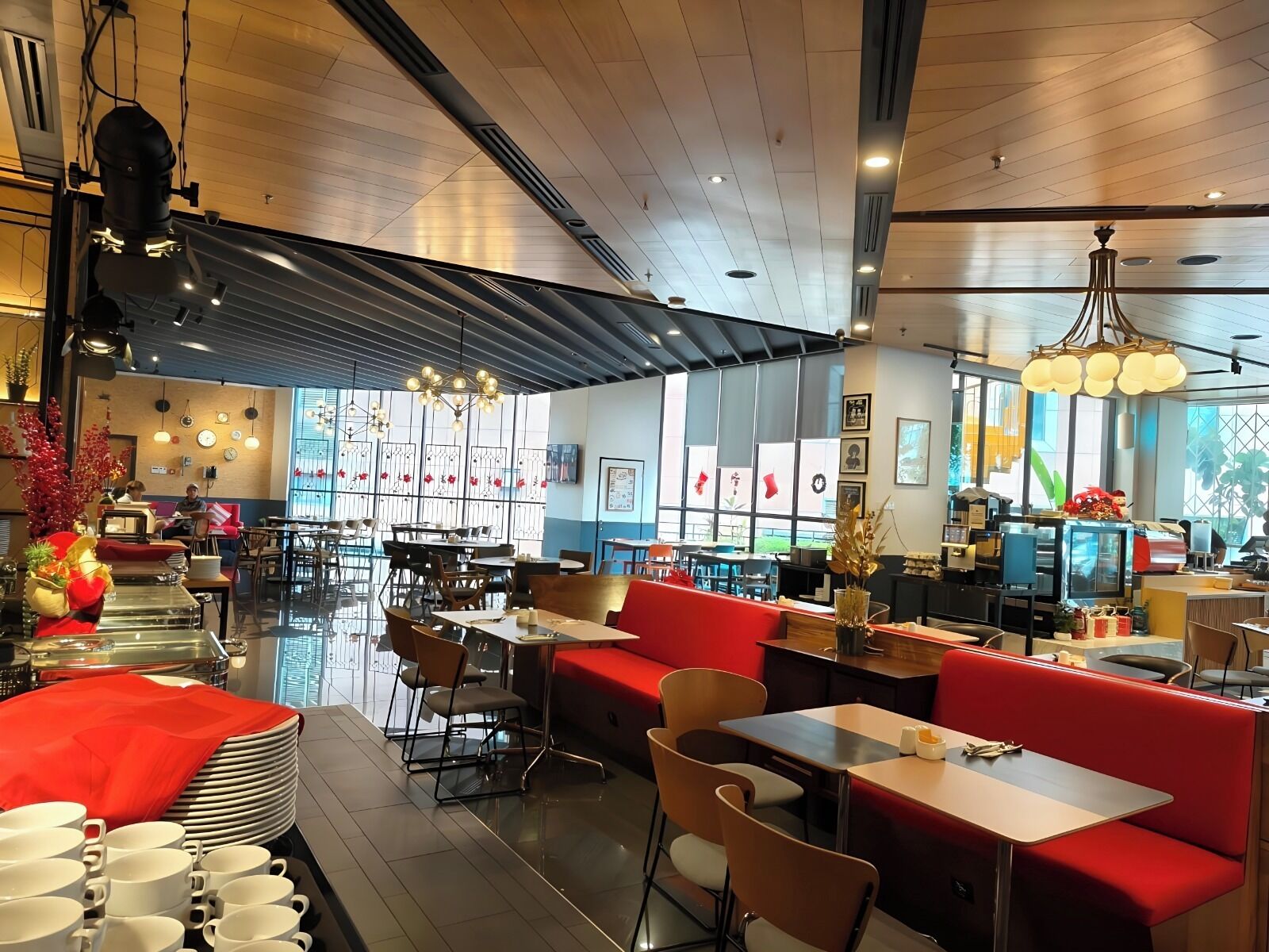 A spacious restaurant with high ceilings, modern lighting, and a mix of seating options including booths and tables.
