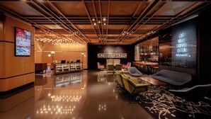 A modern lobby with a wooden ceiling, a reception desk, seating area, and a wall with a motivational quote. - The Kuala Lumpur Journal (Kuala Lumpur)