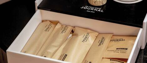 A drawer containing several brown paper bags labeled 'JOURNAL' with a 'VANITY KIT' tag.