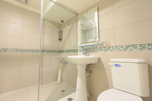 A bathroom with a glass shower enclosure, a pedestal sink, and a toilet. - Travel Young (Kaohsiung)