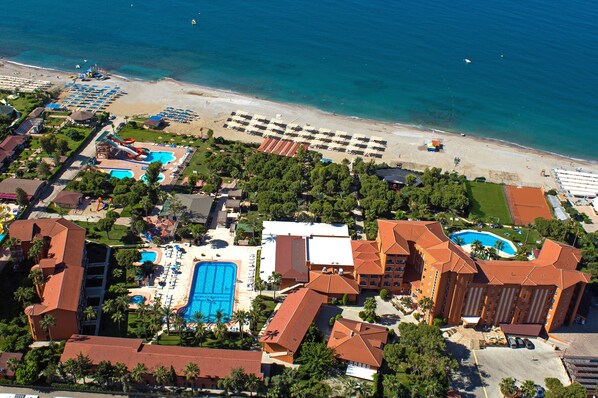 A resort with a large pool, beach access, and multiple buildings.