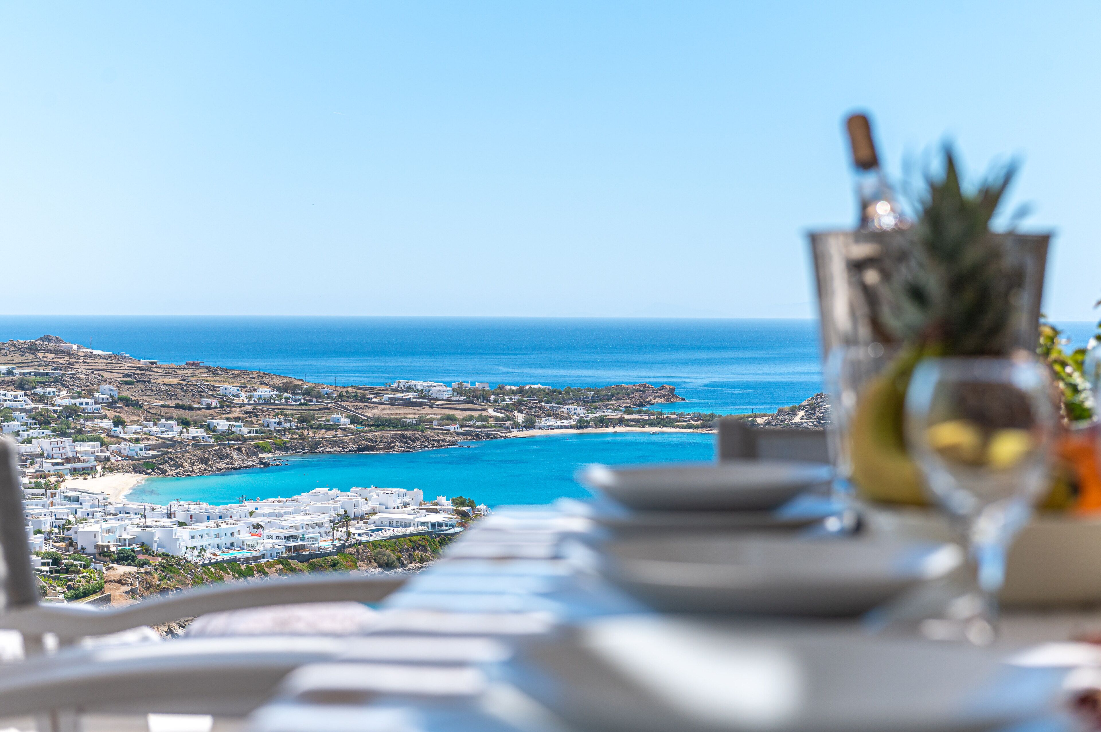A table with a clear view of a coastal town and the sea.