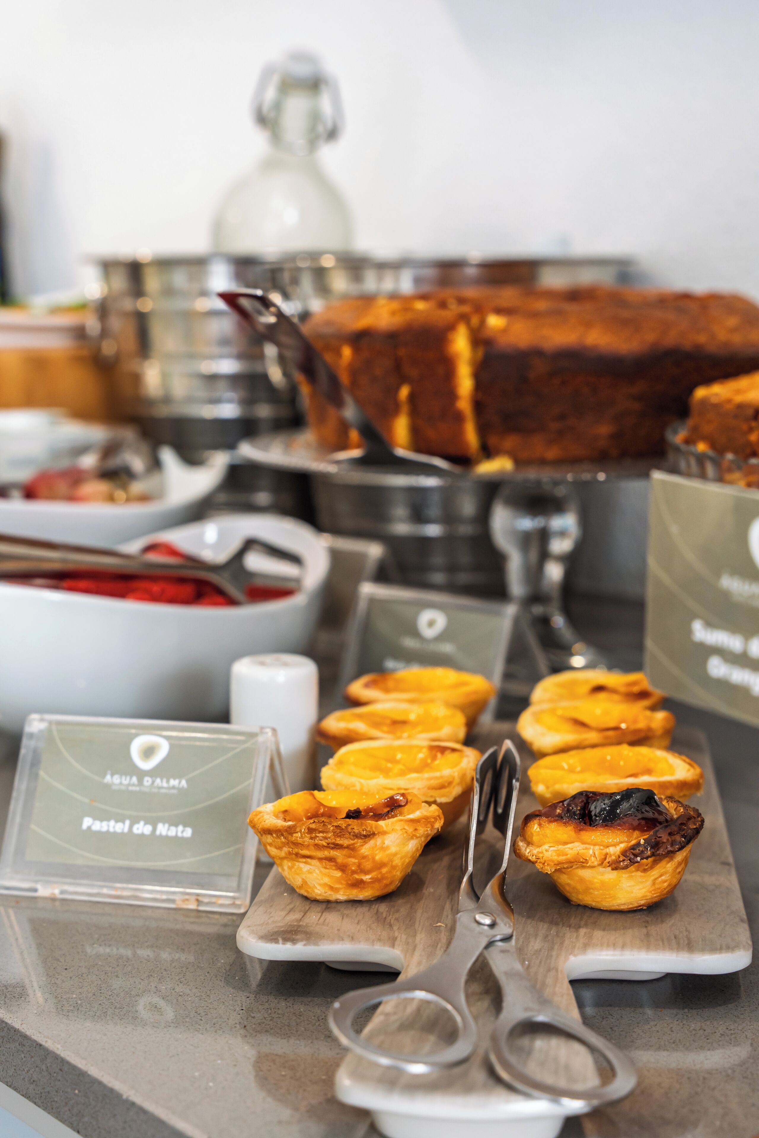 A buffet table with various food items, including pastries and a large cake.