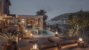 A rooftop pool area with lounge seating, a restaurant, and a view of the ocean. - En Vie Beach Boutique Hotel - Adult Only (Alanya)