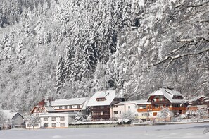 A snow-covered mountain with a row of traditional wooden buildings with sloped roofs, likely a ski resort or mountain lodge. - Ferienwohnung am Rain (Winden im Elztal)