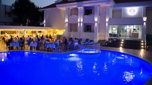 A hotel with a swimming pool, outdoor dining area, and a restaurant. - Emily Rose Hotel (Kemer)