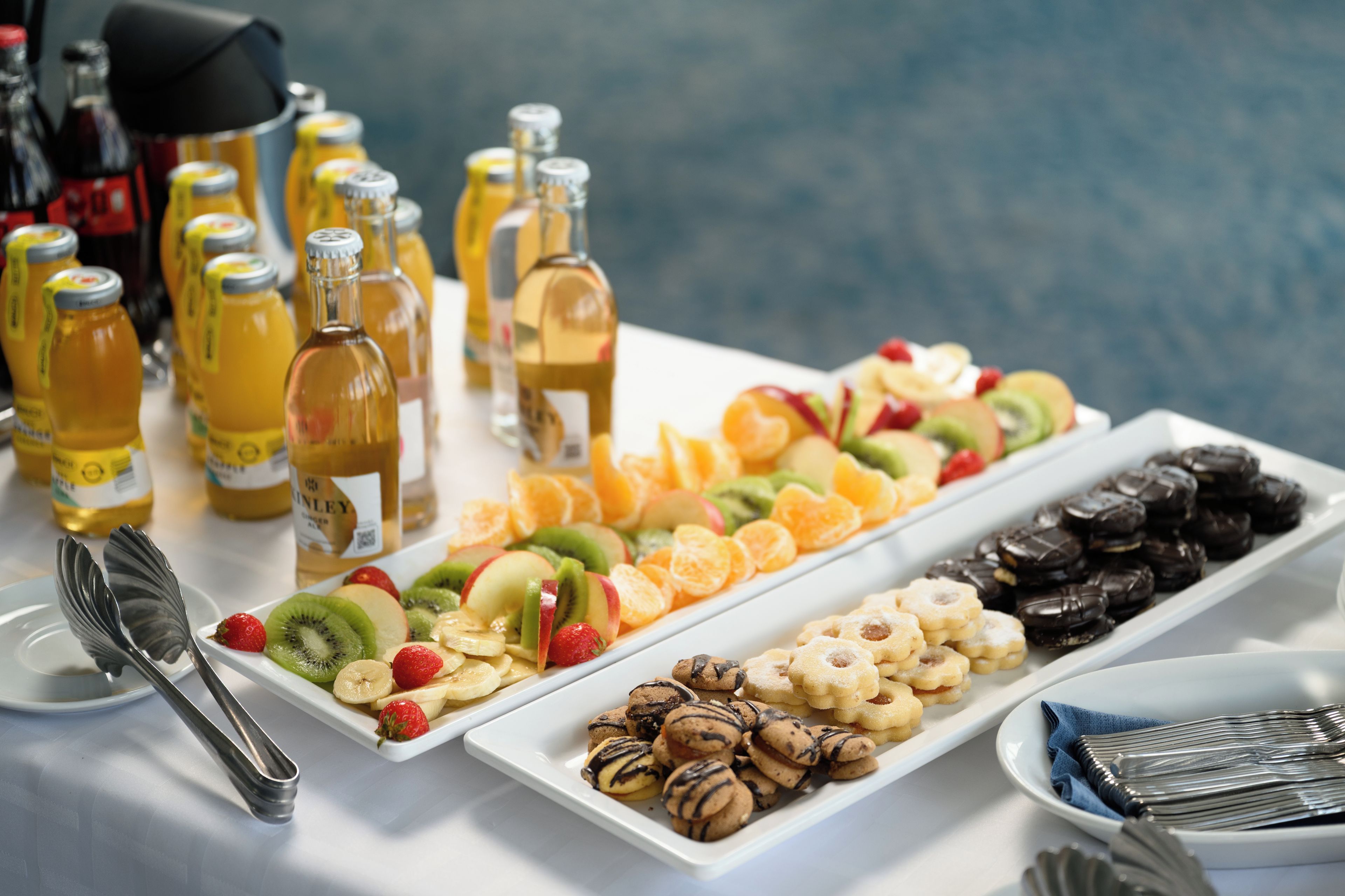 A buffet table with various food items and condiments.