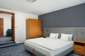 A hotel room with a large bed, a wardrobe, a bedside table, and a mirror. - Hotel Yacht Wellness & Business (Siófok)