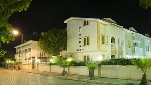 A two-story building with the sign "DINARA HOTEL" on the facade. - Dinara Hotel (Kemer)