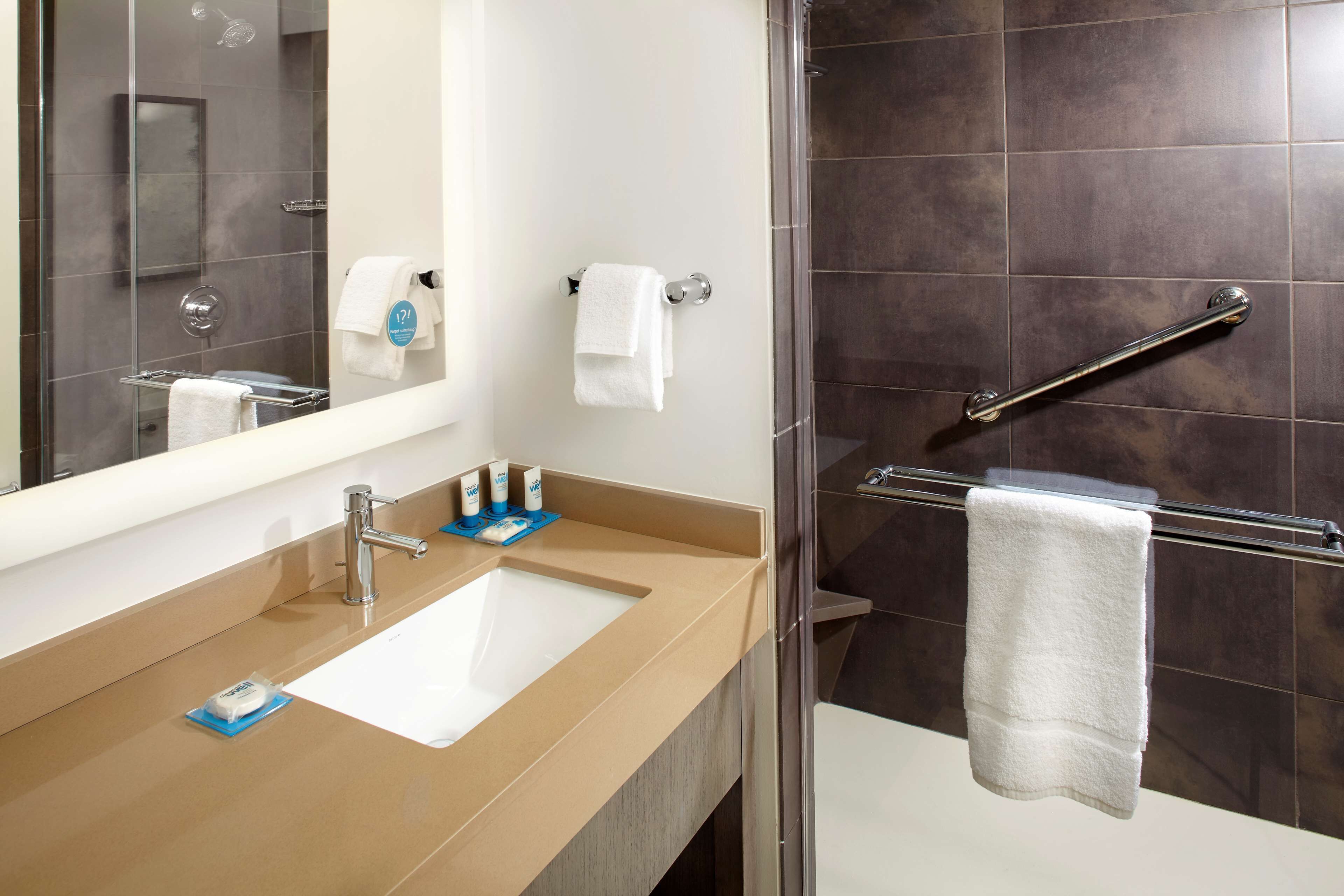 shower, designer toiletries, hair dryer, towels