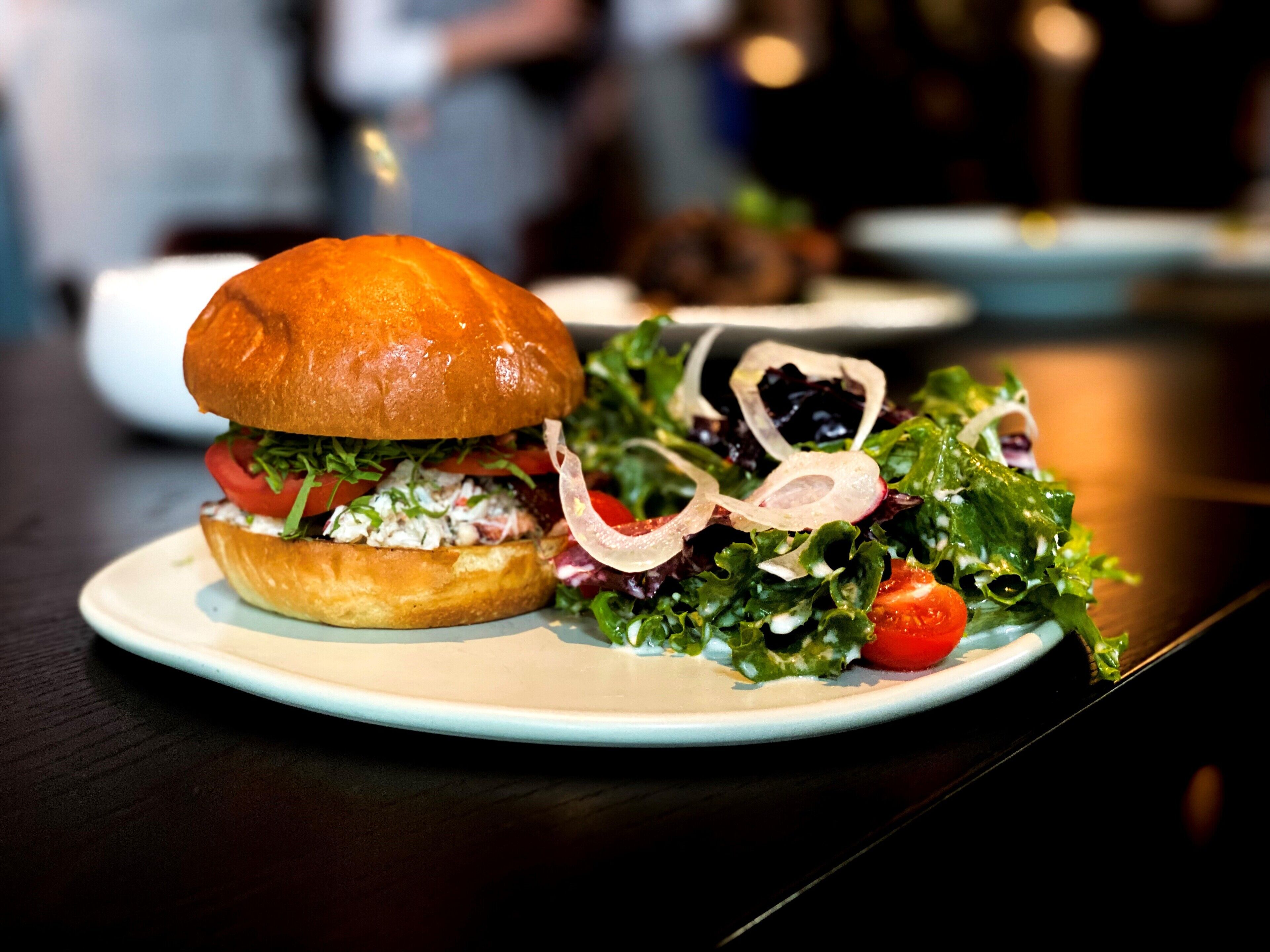 A plate with a sandwich and a salad.