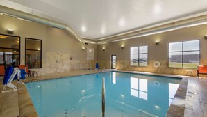 An indoor swimming pool with clear water, tiled walls, and a ceiling with recessed lighting. - Best Western Plus North Platte Inn & Suites (North Platte)