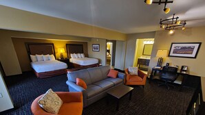 A hotel room with two beds, a sofa, a chair, a desk, and a bathroom. - Best Western Plus North Platte Inn & Suites (North Platte)
