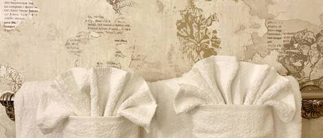 A bathroom with two white towels hanging on a rack.