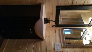 A bathroom with a white sink, a black faucet, and a mirror.