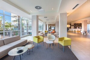 A spacious lobby with a seating area, large windows, and a view of the outdoors. - Abora Buenaventura by Lopesan Hotels (San Bartolomé de Tirajana)