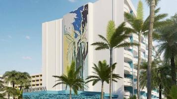 A modern hotel with a large mural on the facade, palm trees, and a covered outdoor area with people.